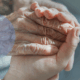 young hand holding old hand