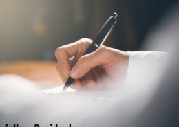 person writing a letter