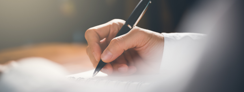 person writing a letter