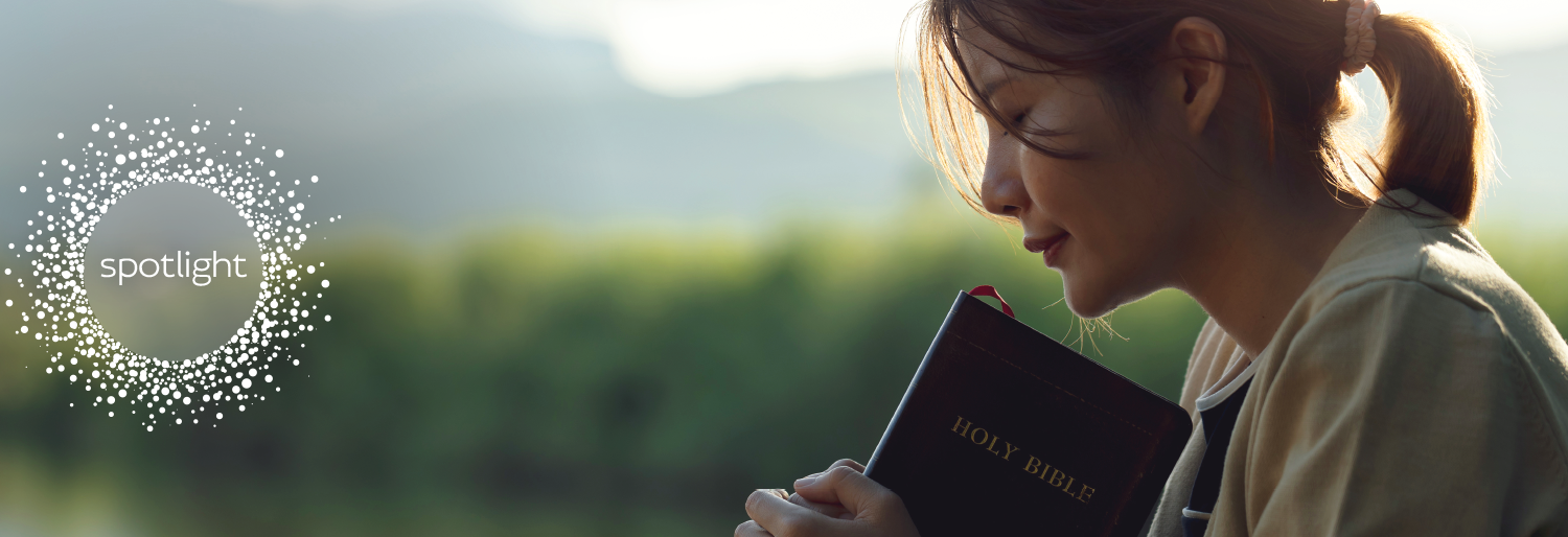 woman holding on to Holy Bible