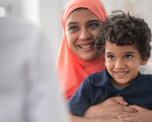 woman of colour in headscarf with her son