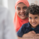 woman of colour in headscarf with her son