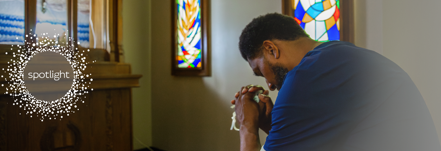 weary healthcarer praying in church