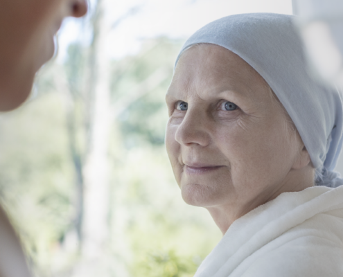 woman smiling though unwell